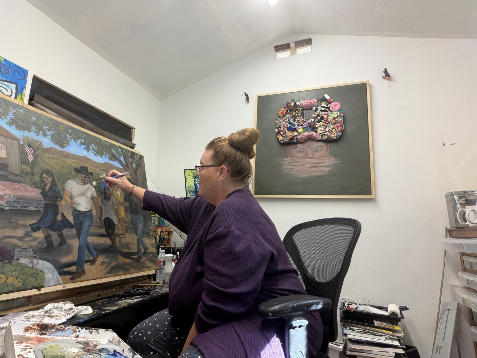 Jennette Wolfe painting Kickin’ Up Dust in her studio